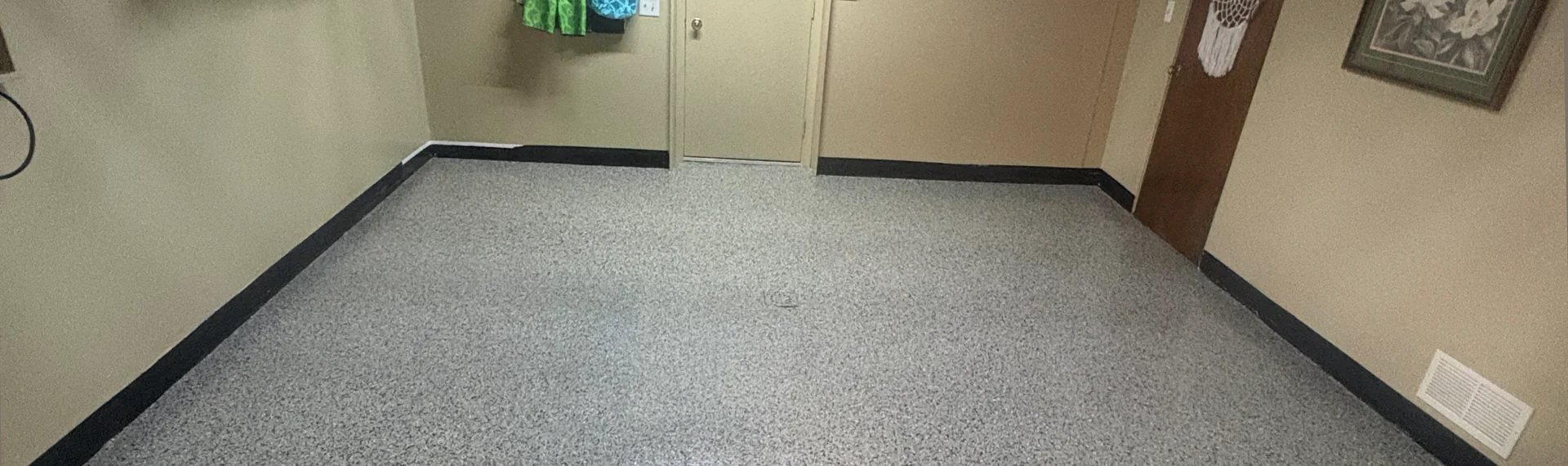 Finished gray decorative flake coating on a basement concrete floor