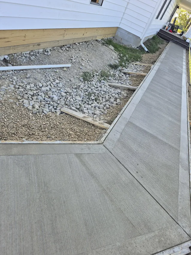Freshly poured concrete driveway entry at a residential property