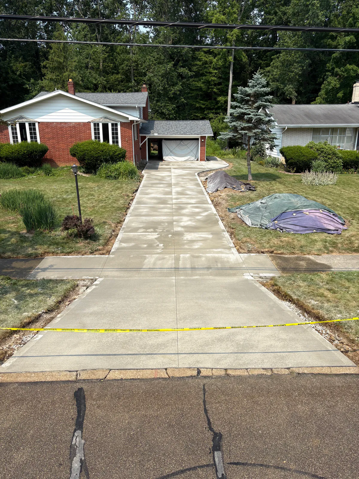 Finished concrete driveway connecting a residential garage to the street