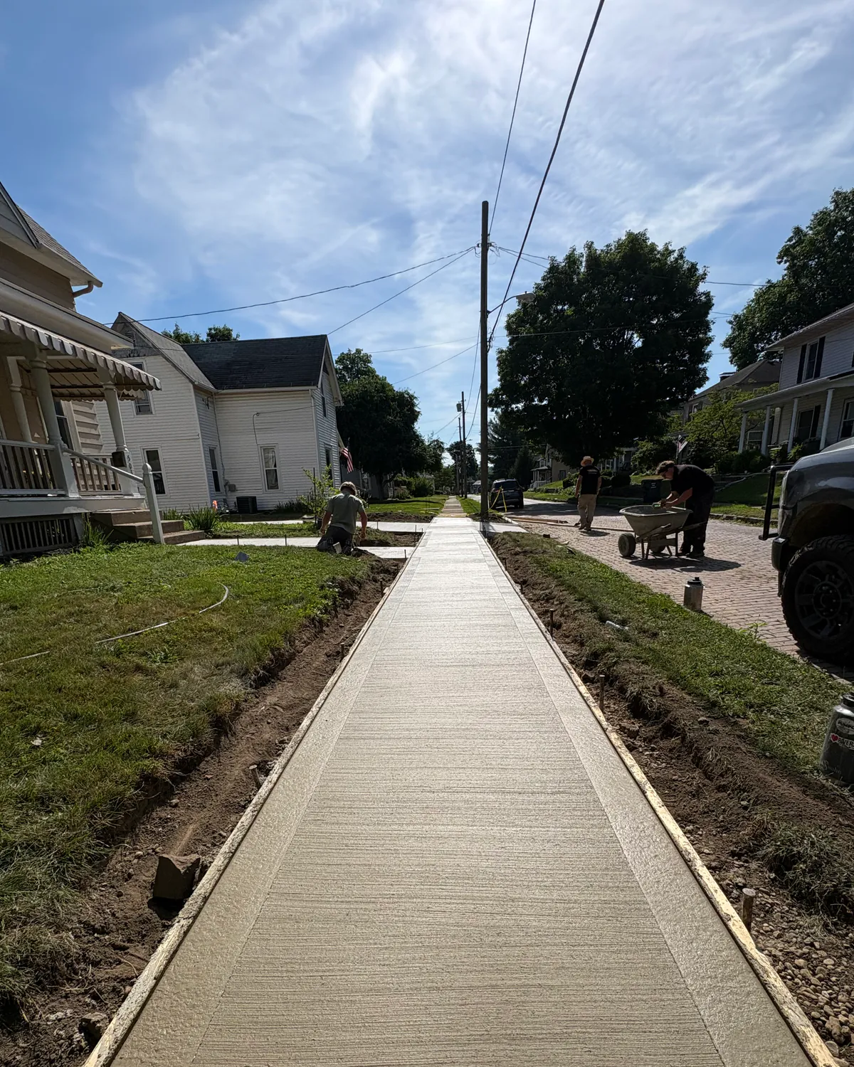 Fresh broom-finish concrete walkway with smooth borders
