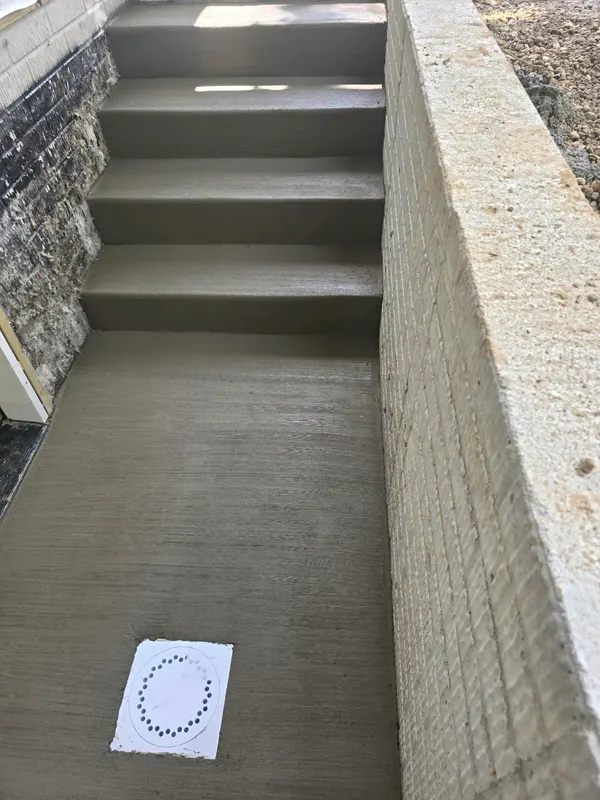 New concrete steps beside a residential entry