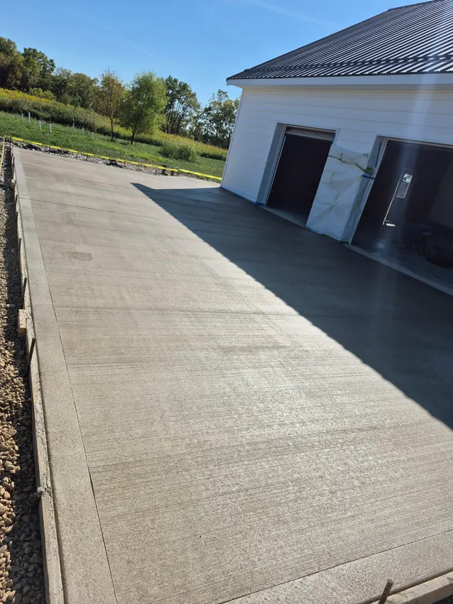 Finished concrete walkway alongside a residential garage