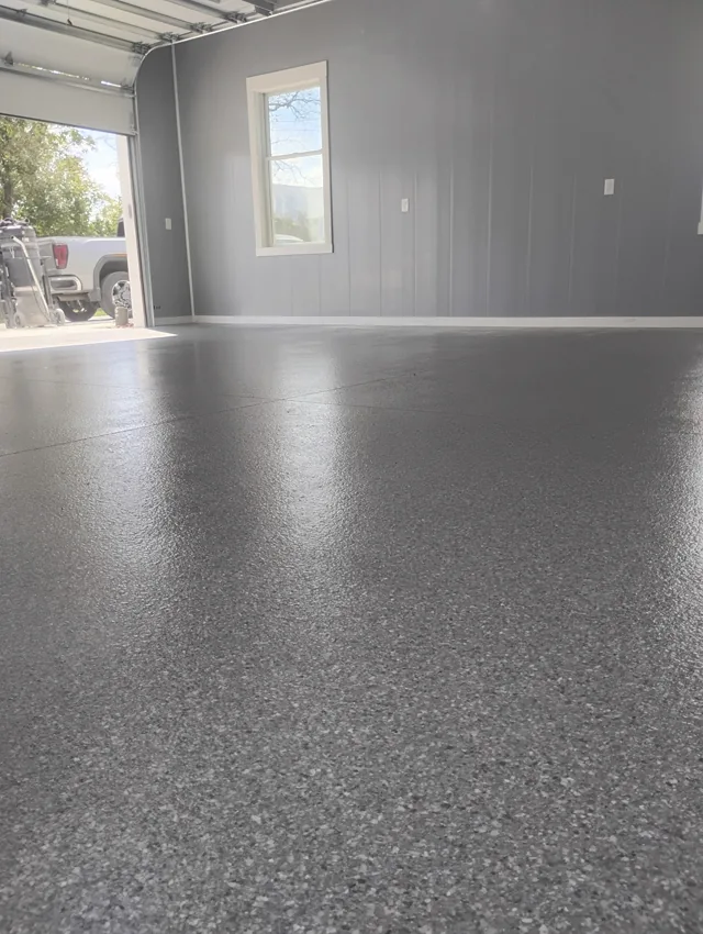 Dark gray decorative coating on a clean residential concrete floor
